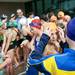 A young swimmer fixes another competitor's swim cap before racing on Tuesday, July 23. Daniel Brenner I AnnArbor.com